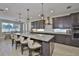 Kitchen featuring granite countertops, stainless appliances, pendant lighting, and a breakfast bar at 2866 Quail Crest Ct, Valrico, FL 33594