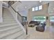 Spacious living room featuring a staircase, tall ceilings, and sliding glass doors to the outside at 2866 Quail Crest Ct, Valrico, FL 33594