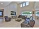 Cozy living room featuring a tall ceiling, large windows, modern decor, and wood-look flooring at 2866 Quail Crest Ct, Valrico, FL 33594