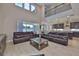 Open-concept living area features balcony, tall windows, kitchen, and neutral decor, providing a welcoming atmosphere at 2866 Quail Crest Ct, Valrico, FL 33594