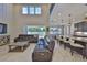 Open-concept living room and kitchen area, featuring a comfortable leather sofa and a kitchen island at 2866 Quail Crest Ct, Valrico, FL 33594