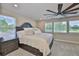 Primary bedroom with large windows bringing in plenty of natural light and large bed at 2866 Quail Crest Ct, Valrico, FL 33594