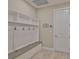 Functional mud room offering a built-in bench with storage, hooks for hanging items, and an entry door at 2866 Quail Crest Ct, Valrico, FL 33594