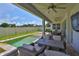 Covered patio with ceiling fans and an outdoor kitchen next to a pool with a sitting area at 2866 Quail Crest Ct, Valrico, FL 33594