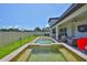 A backyard includes a pool with a sitting area, outdoor kitchen, dining area, and an outdoor living area at 2866 Quail Crest Ct, Valrico, FL 33594