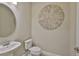 Chic powder room featuring a pedestal sink, toilet, and decorative wall art at 2866 Quail Crest Ct, Valrico, FL 33594