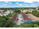 Aerial view of complex with parking, lush greenery, and scenic cityscape skyline in the distance at 3111 W De Leon St # 9, Tampa, FL 33609