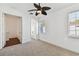 Bright bedroom features a ceiling fan, carpeted floor, and natural light from the window at 3111 W De Leon St # 9, Tampa, FL 33609
