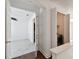Hallway featuring a laundry area and access to carpeted bedroom at 3111 W De Leon St # 9, Tampa, FL 33609