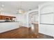 Open concept living space with hardwood floors, modern lighting, and kitchen access at 3111 W De Leon St # 9, Tampa, FL 33609