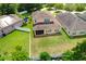 Aerial view of the backyard featuring a large, green lawn enclosed by a white fence at 320 Roxbury Crossing Ct, Valrico, FL 33594