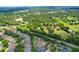Expansive aerial view showcasing the neighborhood's lush greenery, mature trees, and well-maintained homes at 320 Roxbury Crossing Ct, Valrico, FL 33594