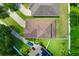 Overhead view of a private home with a brown roof, green yard and long driveway at 320 Roxbury Crossing Ct, Valrico, FL 33594