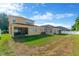 Grassy backyard with a screened-in porch and a white privacy fence, offering a blend of relaxation and outdoor living at 320 Roxbury Crossing Ct, Valrico, FL 33594