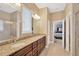 Spacious bathroom with a double sink vanity, granite countertops, and a glass-enclosed shower at 320 Roxbury Crossing Ct, Valrico, FL 33594