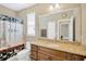 Bathroom with granite countertop, vanity, and a decorative shower curtain with a Paris theme at 320 Roxbury Crossing Ct, Valrico, FL 33594