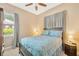 Cozy bedroom with a ceiling fan, natural light, and comfortable furnishings at 320 Roxbury Crossing Ct, Valrico, FL 33594