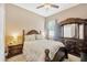 Bedroom with wood furniture, coordinated bedding, ceiling fan, and large window at 320 Roxbury Crossing Ct, Valrico, FL 33594