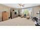 Spacious bonus room with a ceiling fan, a large cabinet, multiple windows, and carpeting at 320 Roxbury Crossing Ct, Valrico, FL 33594