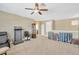 Spacious bonus room features neutral walls, a ceiling fan, and carpeting at 320 Roxbury Crossing Ct, Valrico, FL 33594