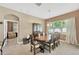 Elegant dining room featuring a large wooden table, china cabinet, and natural light at 320 Roxbury Crossing Ct, Valrico, FL 33594