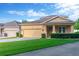 Charming home showcasing well-manicured lawn, landscaped bushes, and a two-car garage at 320 Roxbury Crossing Ct, Valrico, FL 33594