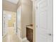 Hallway with tile flooring, storage cabinet and doors leading to other rooms in the house at 320 Roxbury Crossing Ct, Valrico, FL 33594