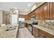 Well-lit kitchen featuring granite countertops, stainless steel appliances and ample cabinetry at 320 Roxbury Crossing Ct, Valrico, FL 33594