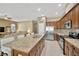 Open kitchen with a large island, stainless steel appliances, and a view of the living area at 320 Roxbury Crossing Ct, Valrico, FL 33594