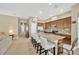 Modern kitchen featuring a large island with seating, stainless steel appliances, and wood cabinetry at 320 Roxbury Crossing Ct, Valrico, FL 33594
