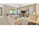 Bright living room featuring neutral colors, plush sofas, and sliding glass doors to the patio at 320 Roxbury Crossing Ct, Valrico, FL 33594