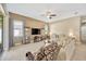 Spacious living room with plush seating, large windows, ceiling fan, and elegant decor at 320 Roxbury Crossing Ct, Valrico, FL 33594