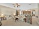 Open-concept living room with plush sofas, a view of the kitchen, and access to the stairs at 320 Roxbury Crossing Ct, Valrico, FL 33594