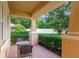 Cozy covered patio with outdoor seating, perfect for enjoying the serene backyard view at 320 Roxbury Crossing Ct, Valrico, FL 33594
