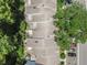 This aerial view highlights the roofing of the townhome style condos and the mature landscaping surrounding the building at 3335 Fox Hunt Dr, Palm Harbor, FL 34683