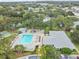 Aerial view of the sparkling community pool, bocce ball court, and clubhouse, providing an idyllic recreational setting at 3335 Fox Hunt Dr, Palm Harbor, FL 34683
