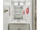 Bright bathroom featuring a large mirror, a white vanity, and love themed decorations at 3335 Fox Hunt Dr, Palm Harbor, FL 34683