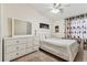 Well-lit bedroom with a white dresser, matching bed, and neutral carpet at 3335 Fox Hunt Dr, Palm Harbor, FL 34683