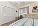 Inviting bedroom with striped bedding, a closet, and soft natural light at 3335 Fox Hunt Dr, Palm Harbor, FL 34683