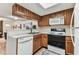 Functional kitchen layout with a view into the living room and a clean white dishwasher at 3335 Fox Hunt Dr, Palm Harbor, FL 34683