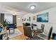 Inviting living room with wood floors and a dining table with a glass top at 3335 Fox Hunt Dr, Palm Harbor, FL 34683