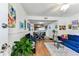 Open living room with hardwood floors, a dining area and open access to the kitchen at 3335 Fox Hunt Dr, Palm Harbor, FL 34683