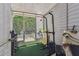 Sunroom with workout equipment overlooking a private outdoor space at 3335 Fox Hunt Dr, Palm Harbor, FL 34683