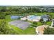 Gorgeous aerial view of community pool and basketball court with lush landscaping and beautiful pond at 33369 Hamilton Hill Ln, Wesley Chapel, FL 33545