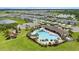 Aerial view of community pool with lounge chairs, picnic tables and playground at 33369 Hamilton Hill Ln, Wesley Chapel, FL 33545