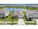 Aerial view of a well-maintained home with a pond view and manicured lawn at 33369 Hamilton Hill Ln, Wesley Chapel, FL 33545