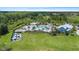 Aerial view of a large community pool with lounge chairs, umbrellas, and splash pad at 33369 Hamilton Hill Ln, Wesley Chapel, FL 33545