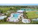 Aerial view of a community pool with hot tub, lounge chairs, and splash pad at 33369 Hamilton Hill Ln, Wesley Chapel, FL 33545