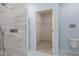 Modern bathroom features a toilet, walk-in closet, and walk-in shower with a rainfall showerhead and elegant tile at 33369 Hamilton Hill Ln, Wesley Chapel, FL 33545