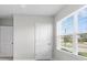 A view of two doors and a window, all painted white, inside the home at 33369 Hamilton Hill Ln, Wesley Chapel, FL 33545